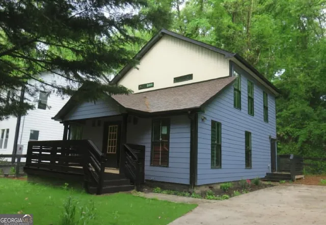 a front view of a house with garden