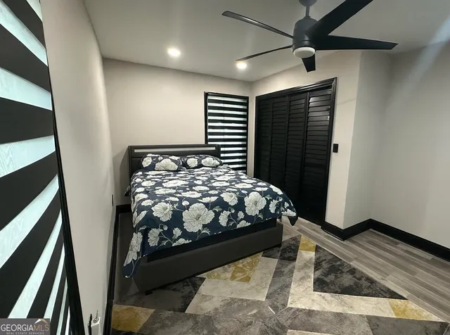 a bedroom with a bed and a black walk in closet