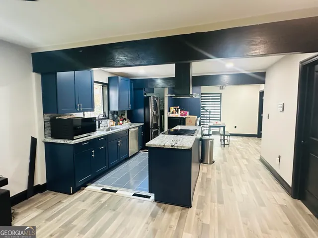 a view of a room with furniture and wooden floor