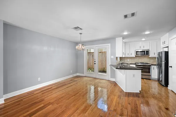 a kitchen with granite countertop a refrigerator stove top oven and sink