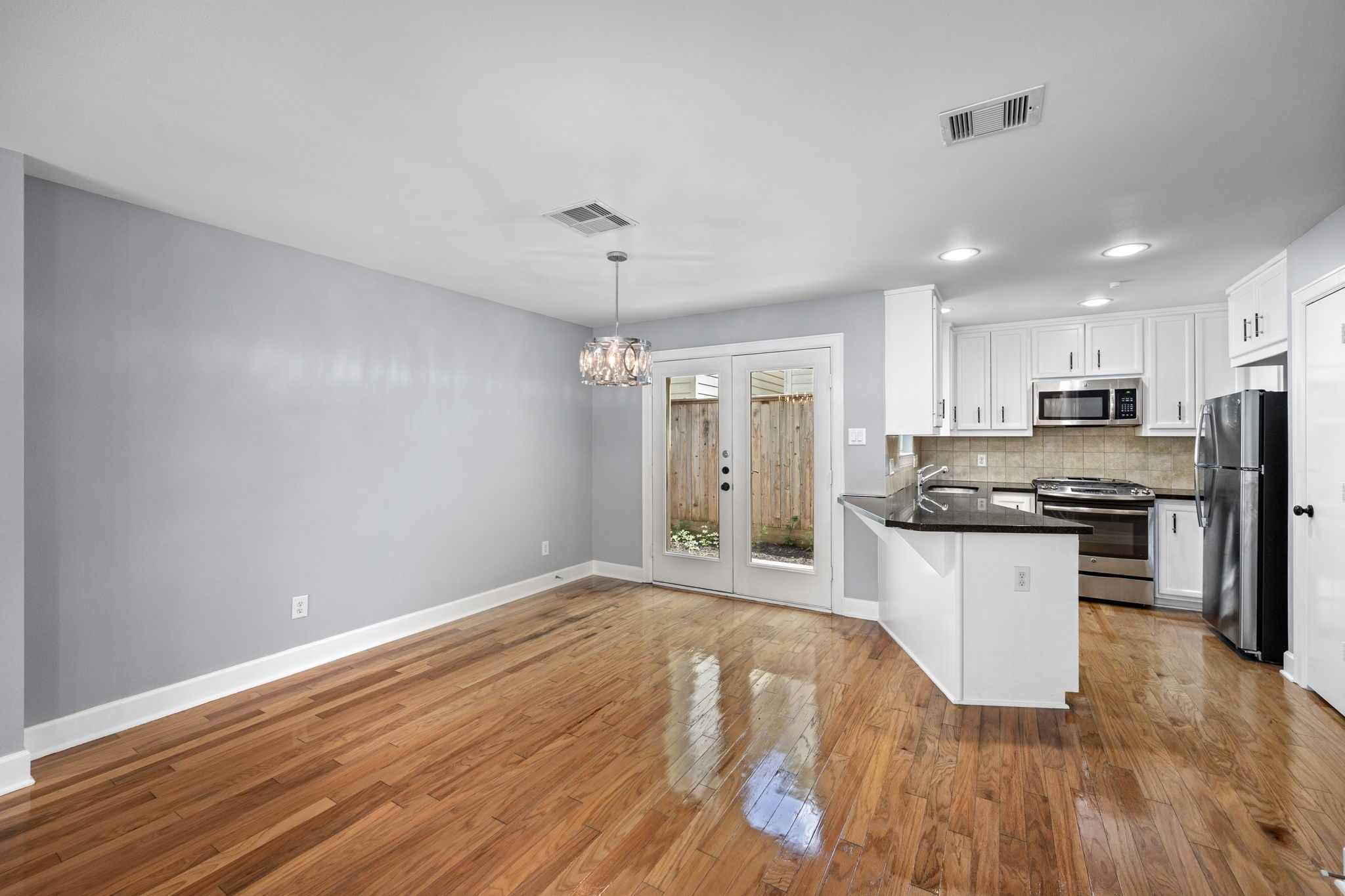 5951 S Loop East, Unit 50 Houston, TX 77033 - Photo 7 of 23 a kitchen with granite countertop a refrigerator stove top oven and sink