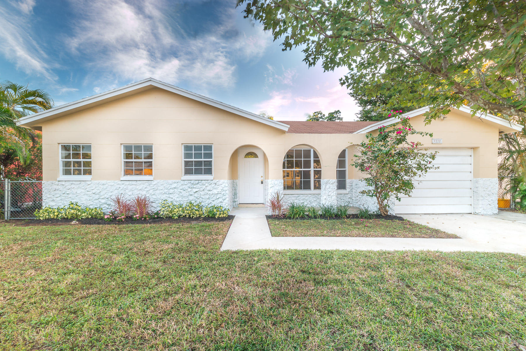 9222 Southwest 1st Place Boca Raton, FL 33428 - Photo 1 of 23 a front view of a house with a yard