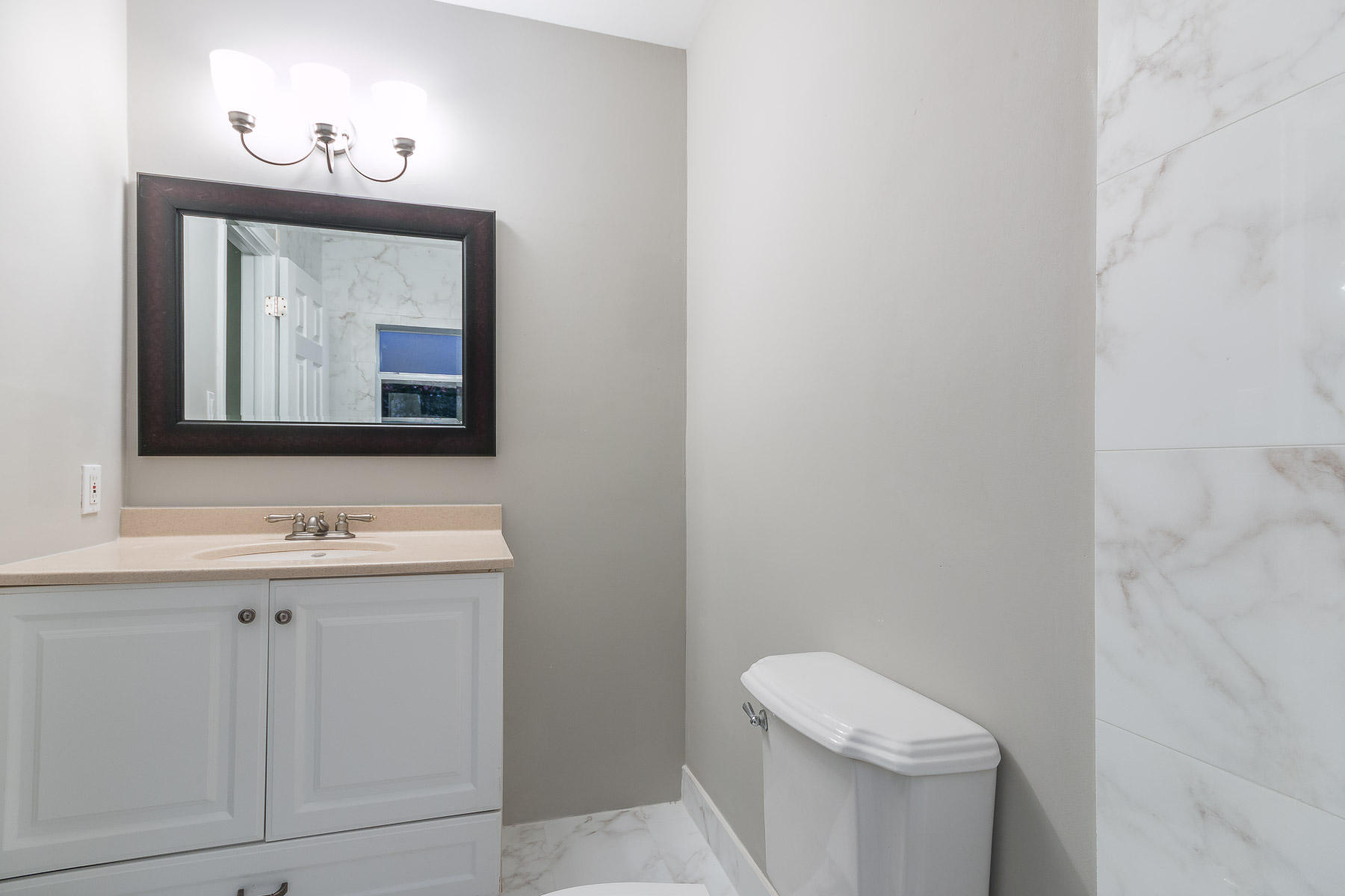 9222 Southwest 1st Place Boca Raton, FL 33428 - Photo 13 of 23 a bathroom with a toilet sink and mirror