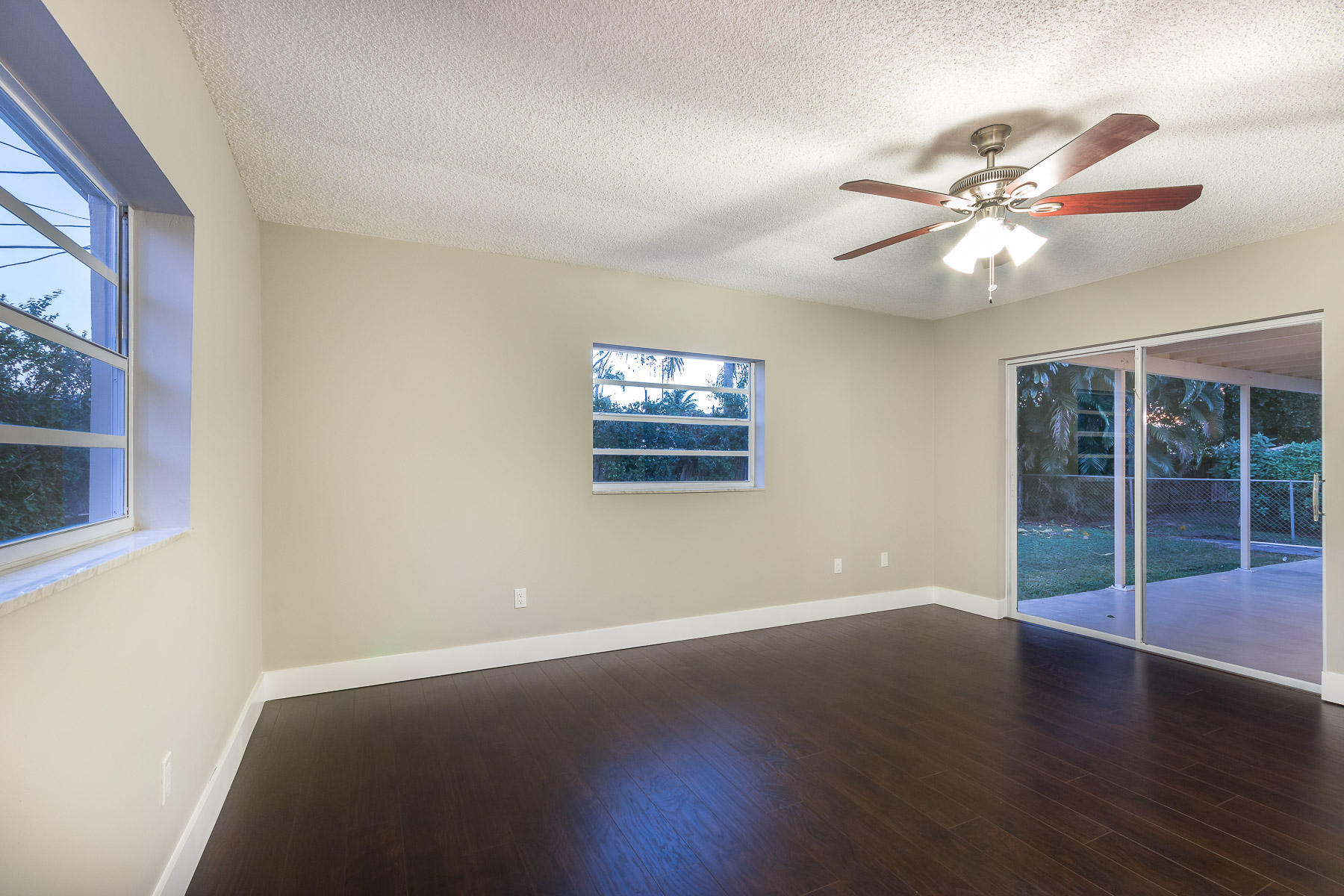 9222 Southwest 1st Place Boca Raton, FL 33428 - Photo 16 of 23 a view of a big room with wooden floor and windows