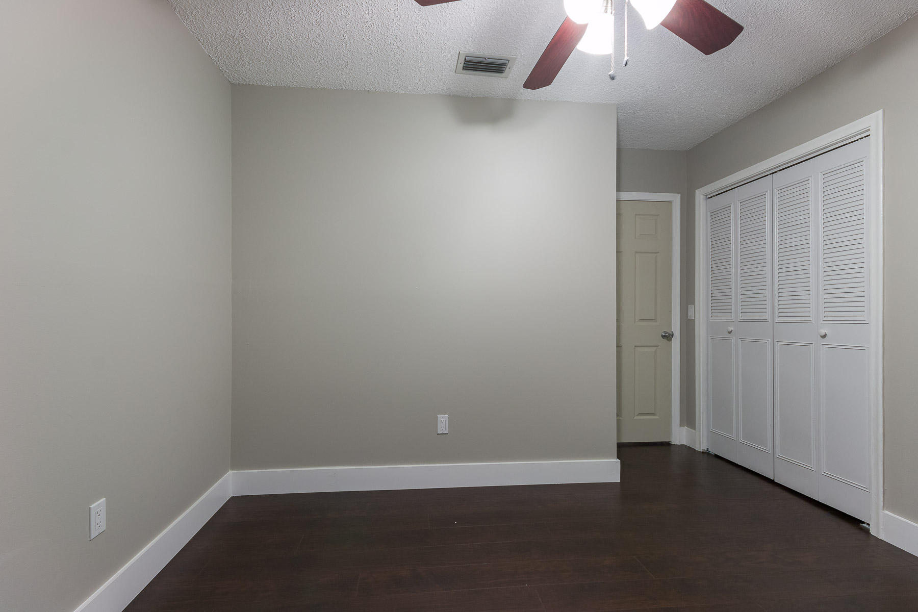 9222 Southwest 1st Place Boca Raton, FL 33428 - Photo 18 of 23 an empty room with a ceiling fan and painted walls