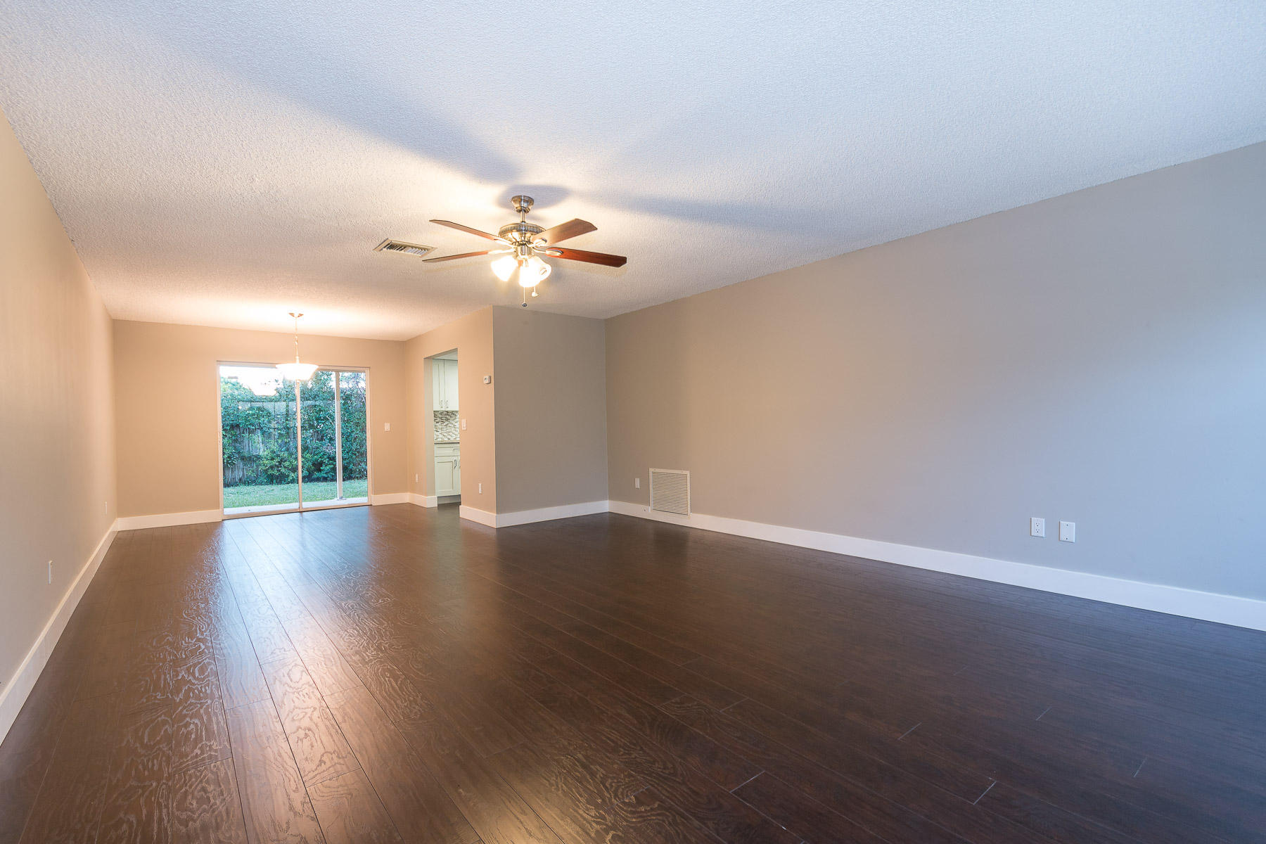 9222 Southwest 1st Place Boca Raton, FL 33428 - Photo 7 of 23 a view of an empty room with wooden floor and a window