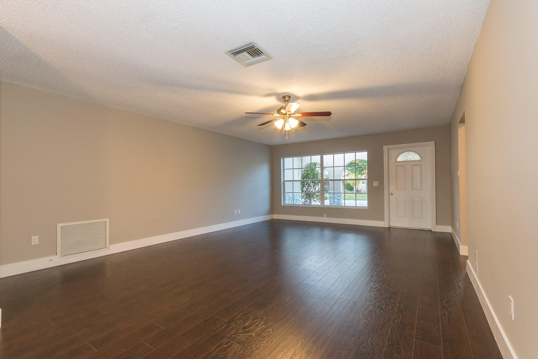 9222 Southwest 1st Place Boca Raton, FL 33428 - Photo 8 of 23 a view of an empty room with wooden floor and a window