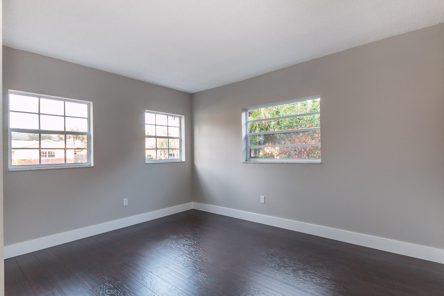 9222 Southwest 1st Place Boca Raton, FL 33428 - Photo 9 of 23 an empty room with wooden floor and windows