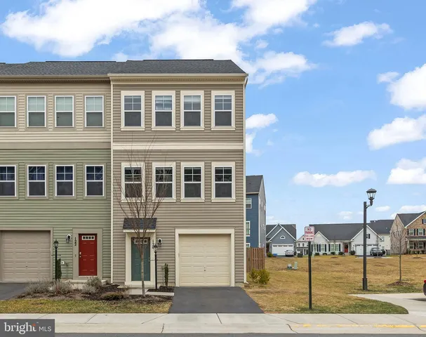 a front view of a building with a garden