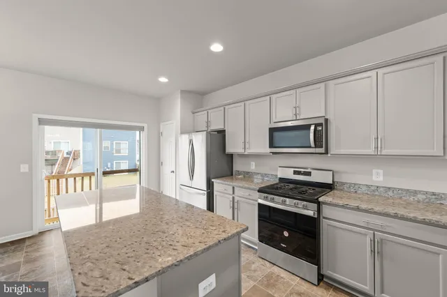 a kitchen with stainless steel appliances a sink stove and refrigerator