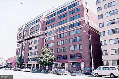1245 13th Street Northwest, Unit 600 Washington, DC 20005 - Photo 1 of 1 a front view of a building with lot of cars and trees