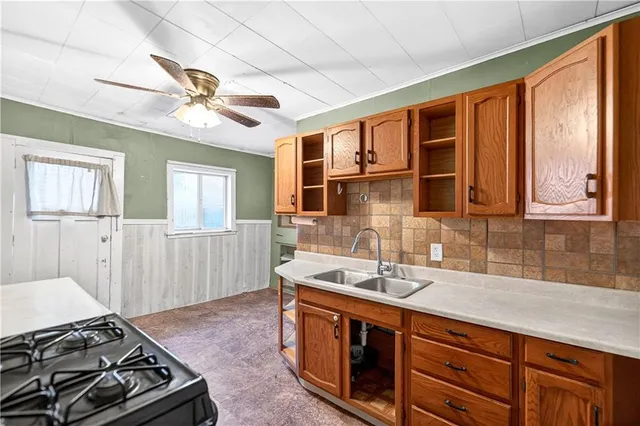a kitchen with stainless steel appliances granite countertop a sink stove and cabinets