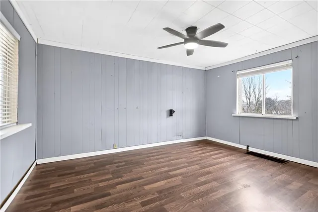 wooden floor in an empty room with a window