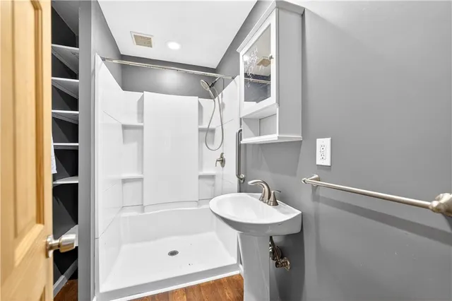 a view of a big room with a ceiling fan and window