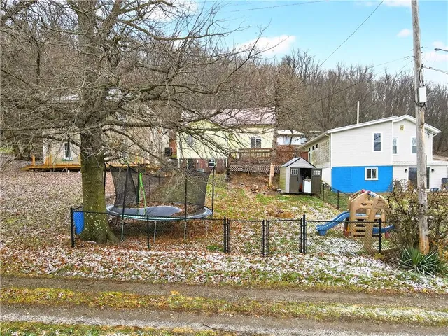 a view of a house with a yard patio and fire pit