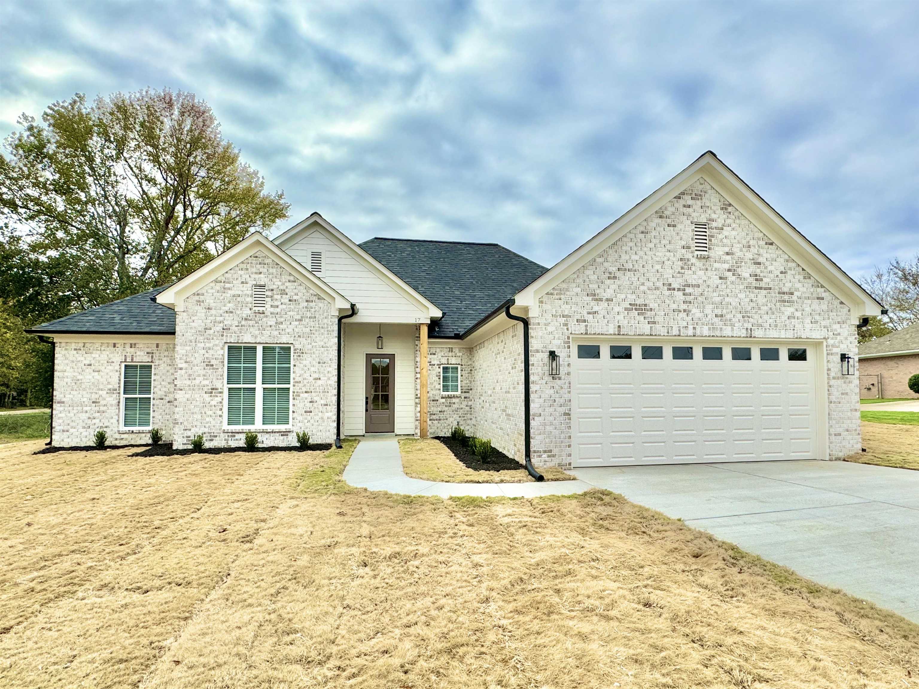 17 Edith Lane Atoka, TN 38004 - Photo 1 of 36 a front view of a house with a yard and garage
