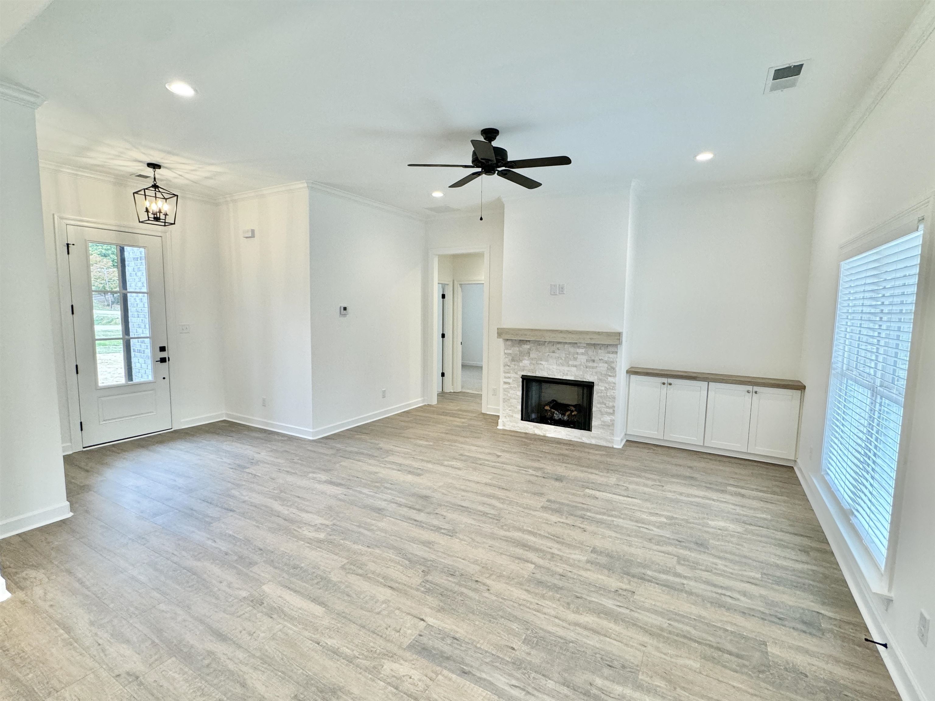 17 Edith Lane Atoka, TN 38004 - Photo 11 of 36 an empty room with windows and fireplace