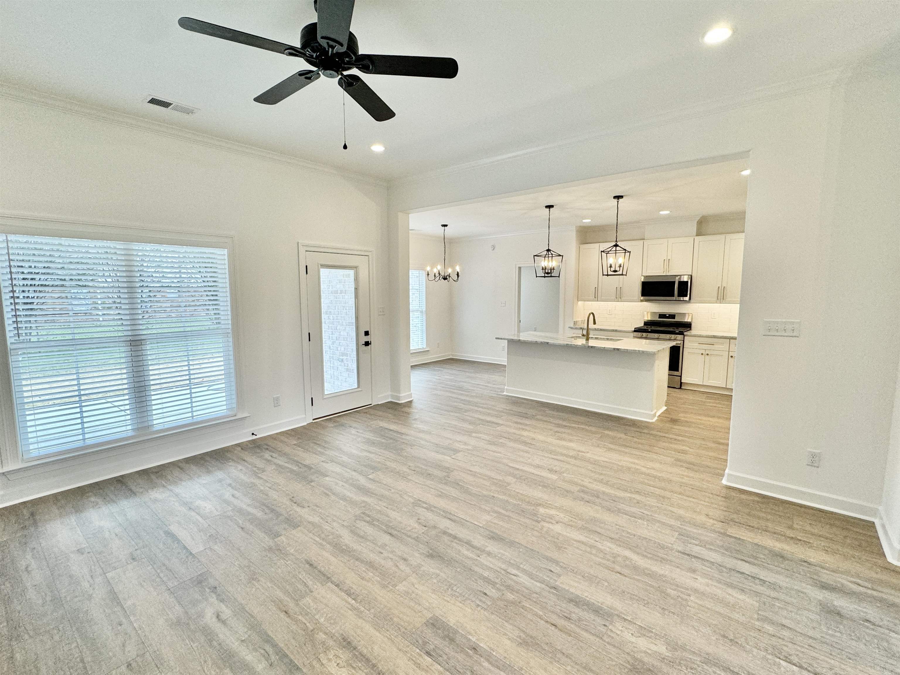 17 Edith Lane Atoka, TN 38004 - Photo 12 of 36 a view of empty room with wooden floor and windows