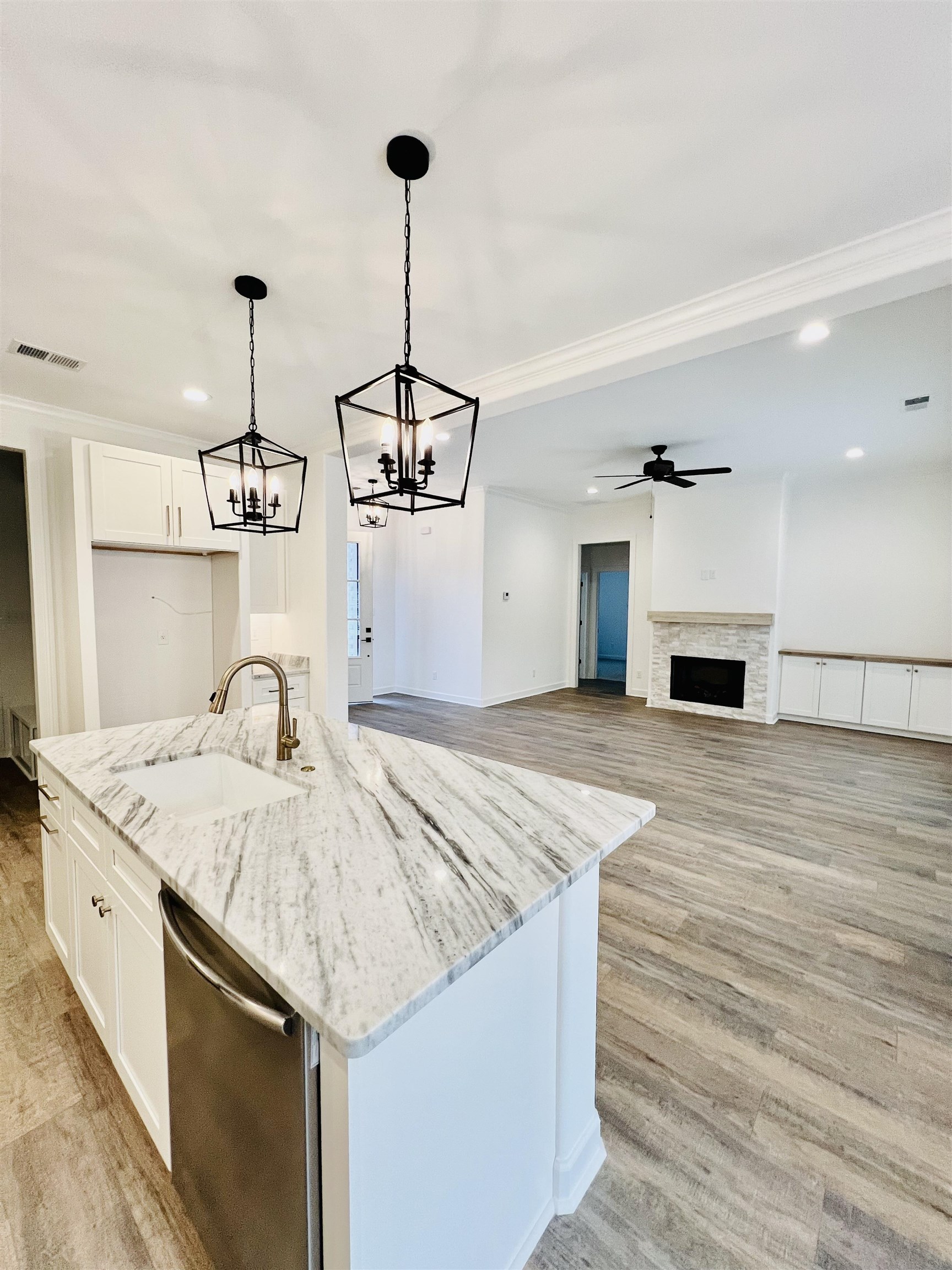 17 Edith Lane Atoka, TN 38004 - Photo 13 of 36 a kitchen with kitchen island a stove a sink and a wooden floor