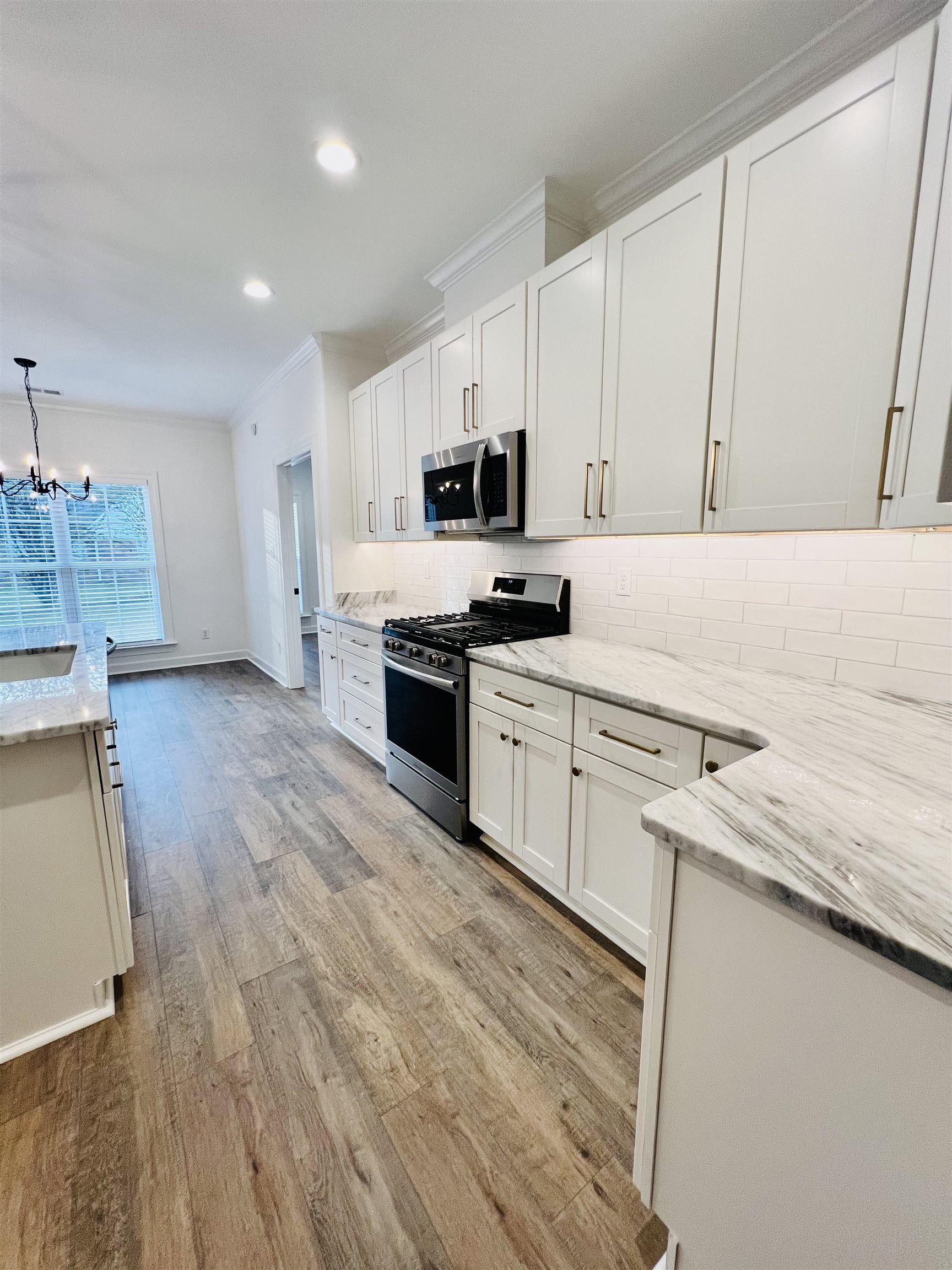 17 Edith Lane Atoka, TN 38004 - Photo 15 of 36 a kitchen with stainless steel appliances granite countertop a stove a sink and a microwave