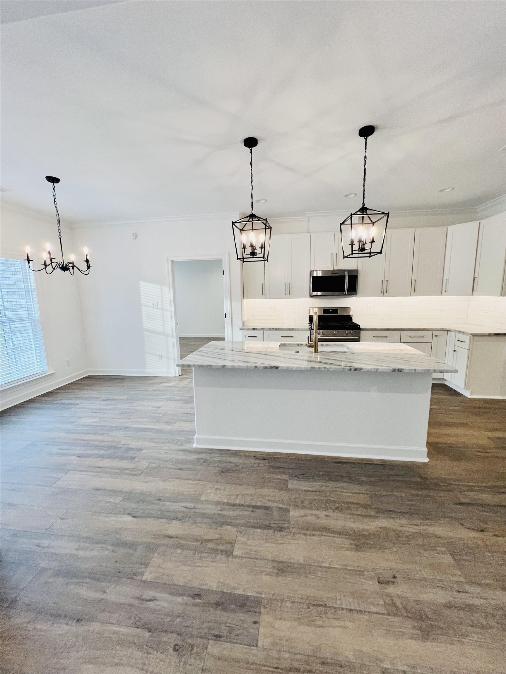 17 Edith Lane Atoka, TN 38004 - Photo 16 of 36 a view of kitchen with kitchen island stainless steel appliances wooden floor and chandelier