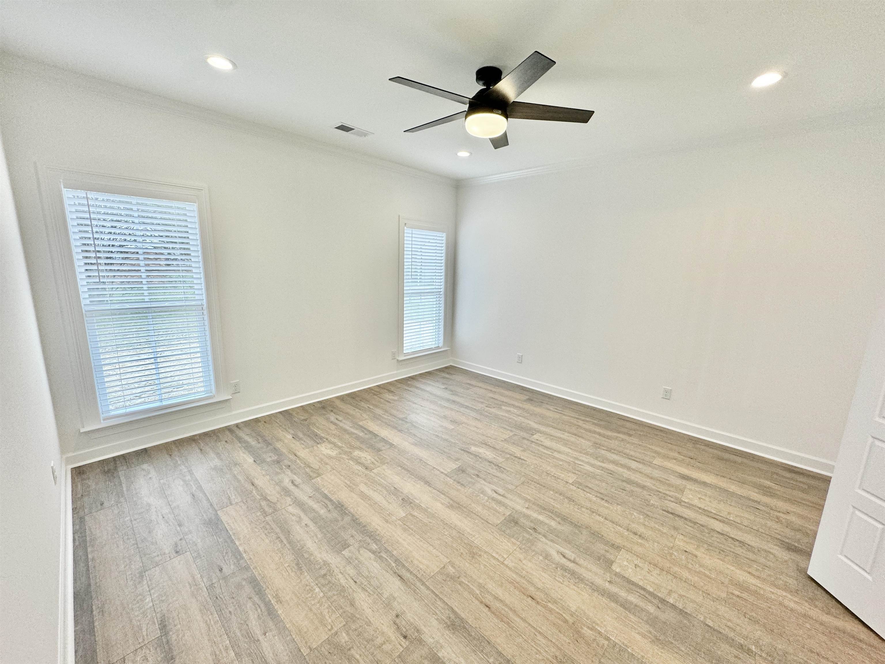 17 Edith Lane Atoka, TN 38004 - Photo 19 of 36 an empty room with wooden floor and windows