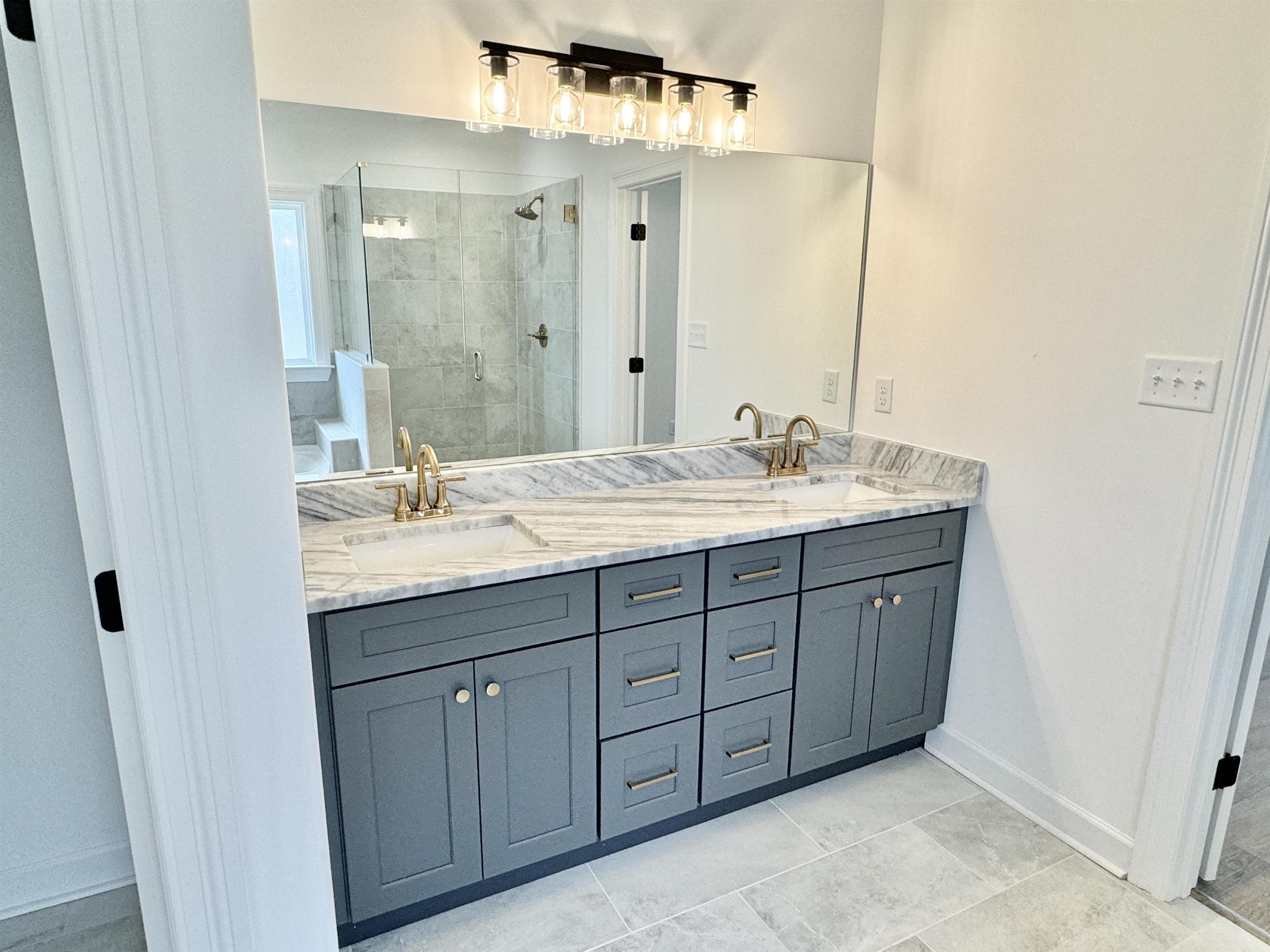 17 Edith Lane Atoka, TN 38004 - Photo 21 of 36 a bathroom with a double vanity sink and mirror