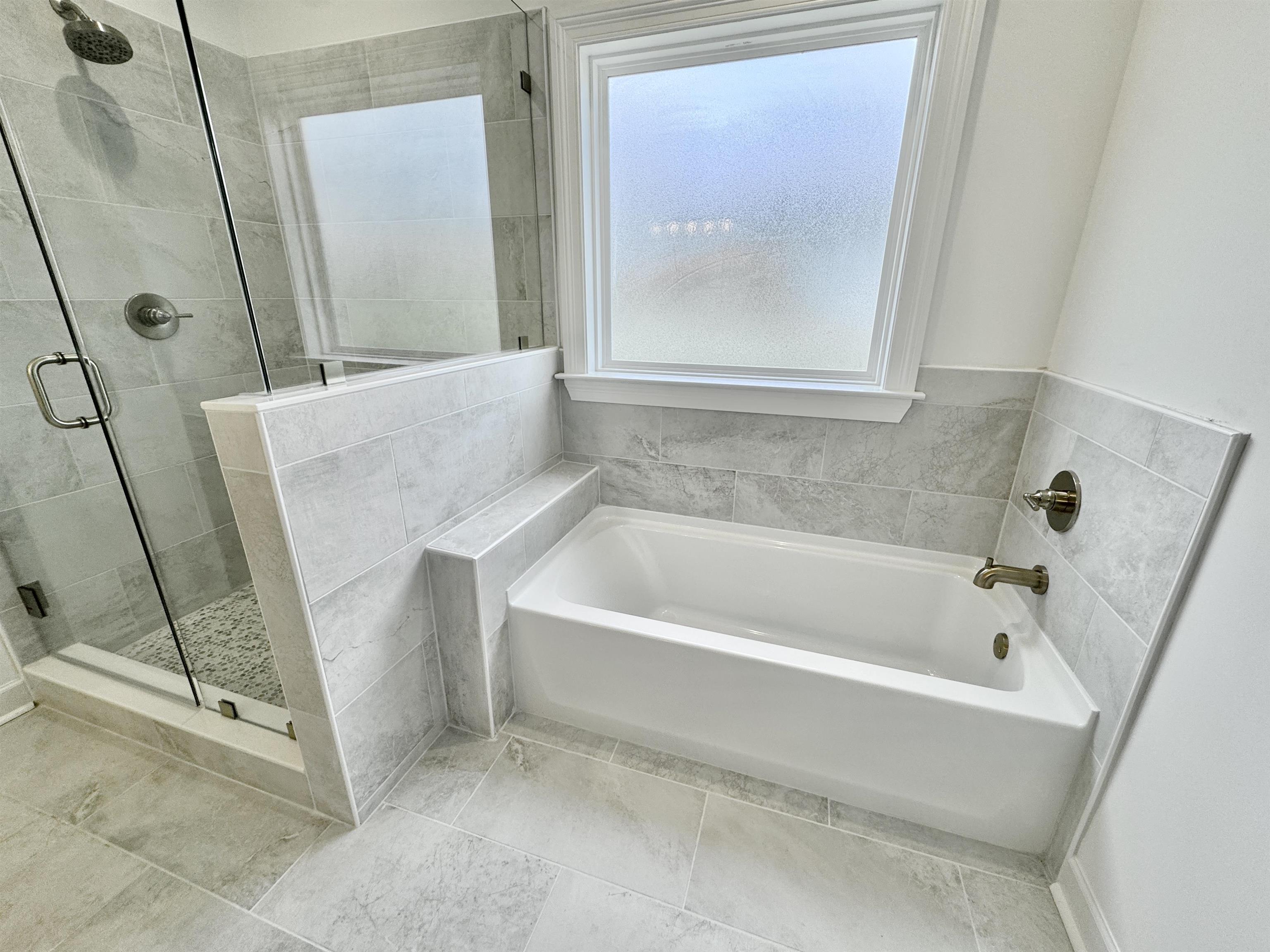 17 Edith Lane Atoka, TN 38004 - Photo 23 of 36 a bathroom with a tub a mirror and a shower