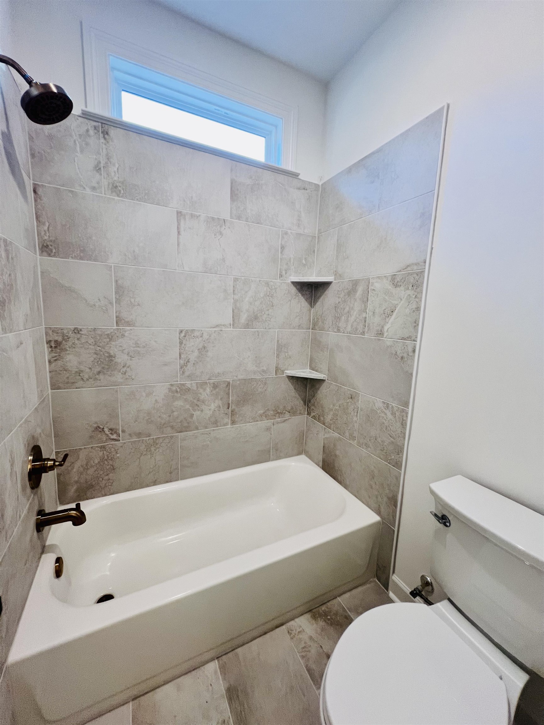 17 Edith Lane Atoka, TN 38004 - Photo 32 of 36 a white bath tub sitting next to a white toilet and a shower