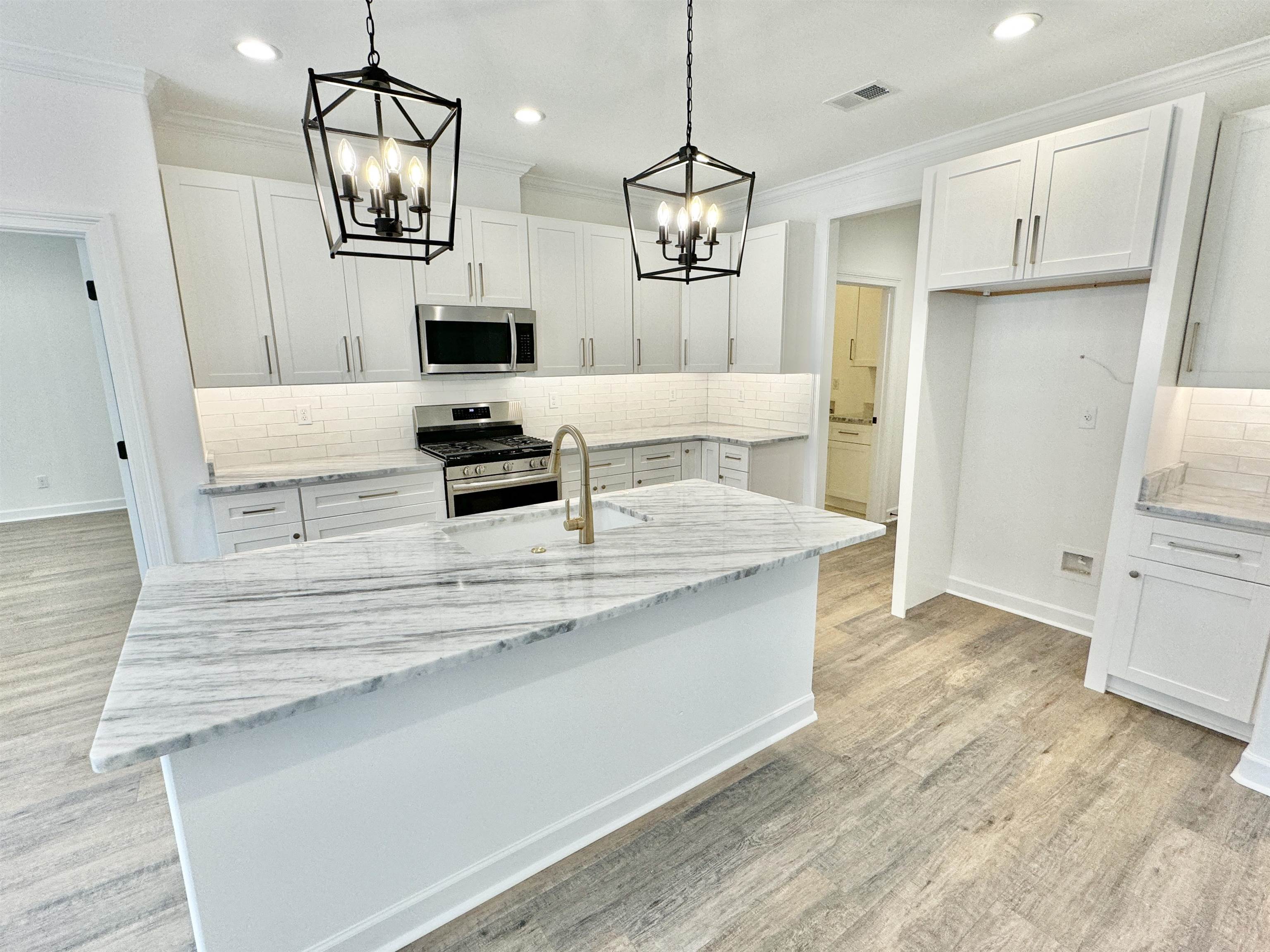 17 Edith Lane Atoka, TN 38004 - Photo 7 of 36 a kitchen with stainless steel appliances kitchen island granite countertop a stove a sink and a refrigerator