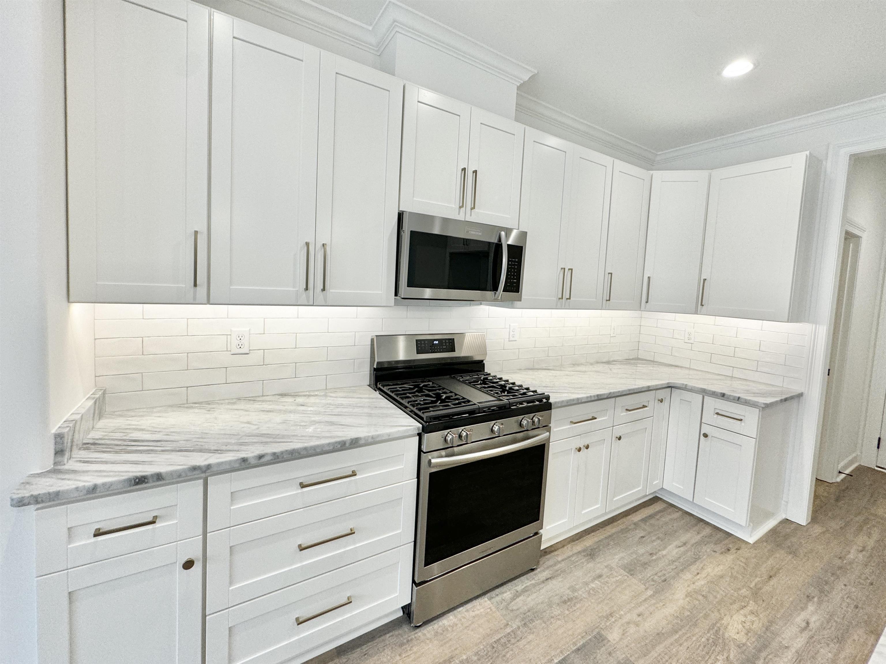17 Edith Lane Atoka, TN 38004 - Photo 8 of 36 a kitchen with granite countertop white cabinets and stainless steel appliances