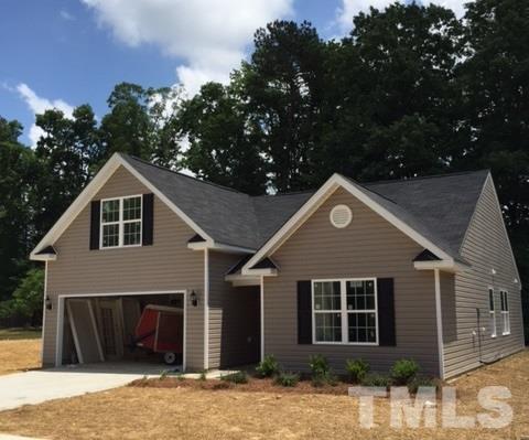 2925 Smooth Stone Trail Raleigh, NC 27610 - Photo 1 of 10 a front view of a house with a garden
