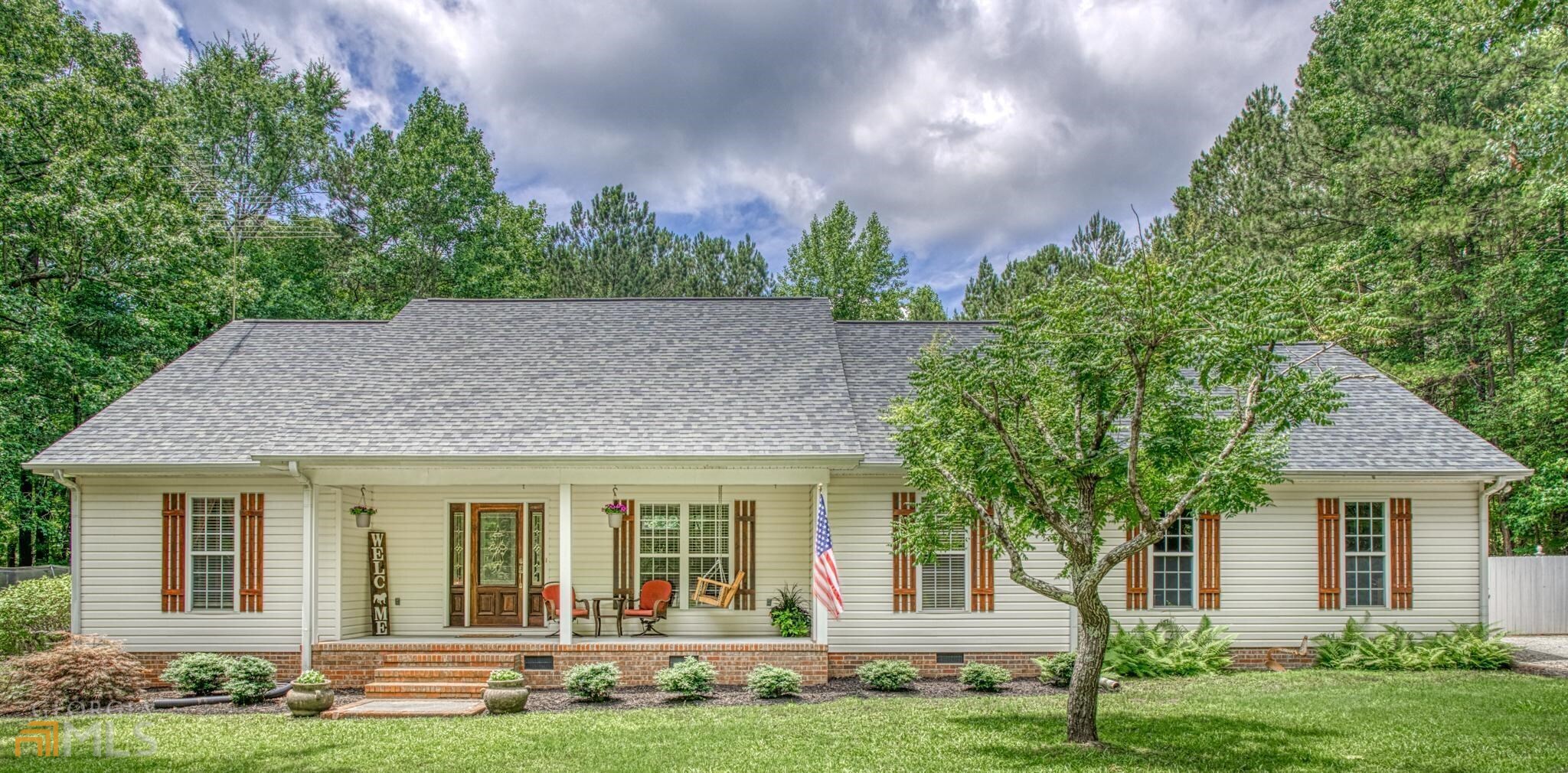 56 Mountain View Road Molena, GA 30258 - Photo 1 of 1 a view of a house with garden and plants