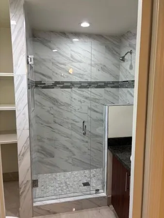 a bathroom with a toilet and a shower