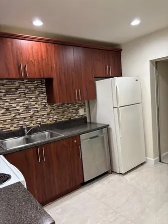 a kitchen with a sink and a stove top oven