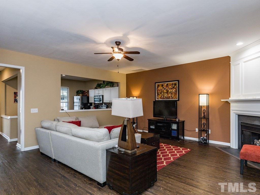 4312 Vienna Crest Drive Raleigh, NC 27613 - Photo 14 of 26 a living room with furniture and a fireplace