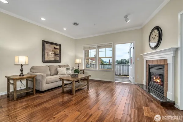a living room with furniture a large window and a fireplace