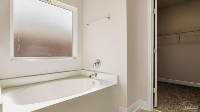 a bathroom with a bathtub and a window