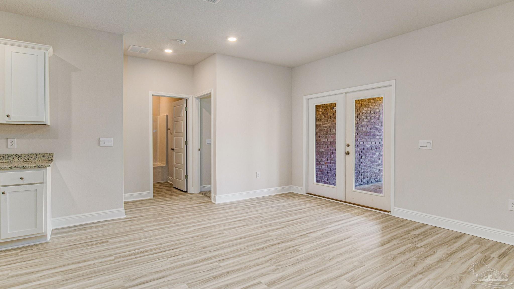 3472 Crossvine Road Cantonment, FL 32533 - Photo 9 of 23 an empty room with wooden floor & closet area