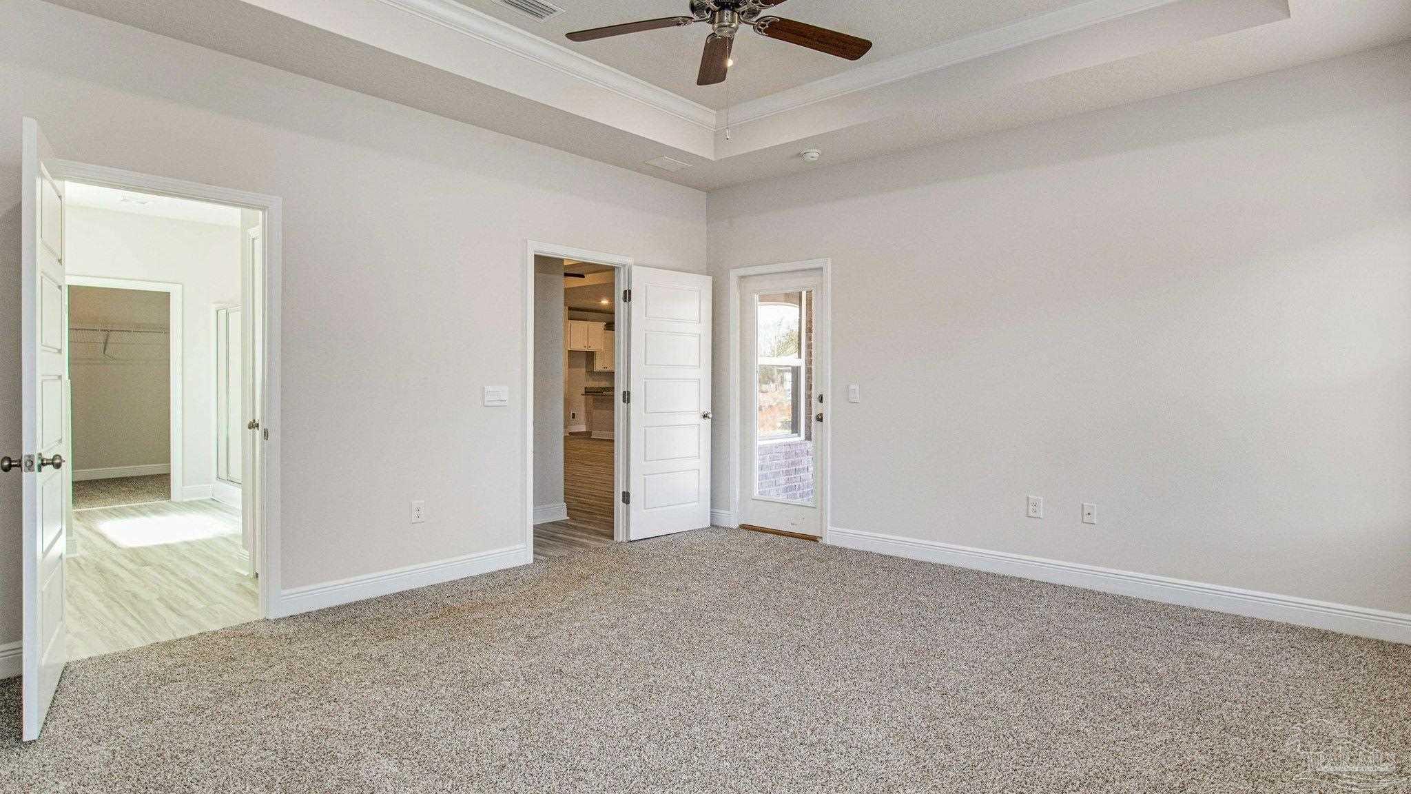 3472 Crossvine Road Cantonment, FL 32533 - Photo 10 of 23 an empty room with a chandelier fan and windows