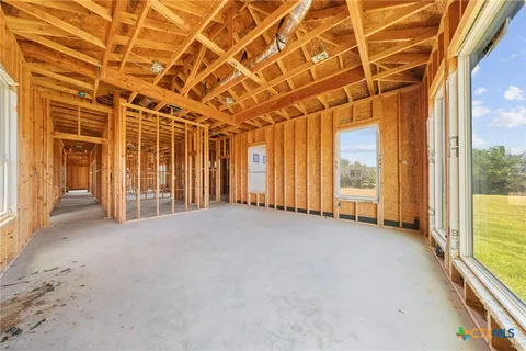 a view of hallway with furniture and a large window