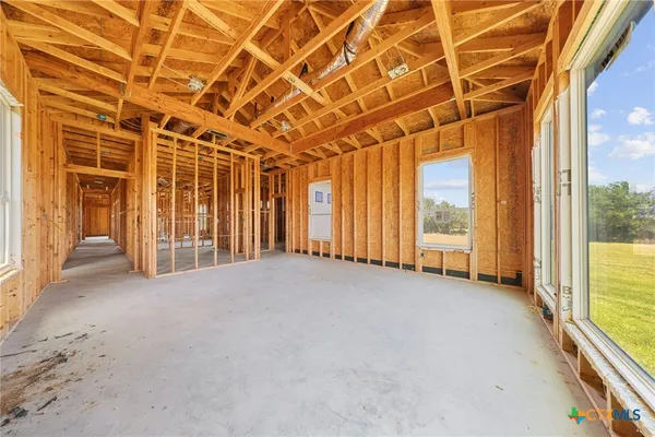 a view of hallway with furniture and a large window