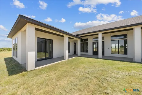 a view of a house with a swimming pool and a yard