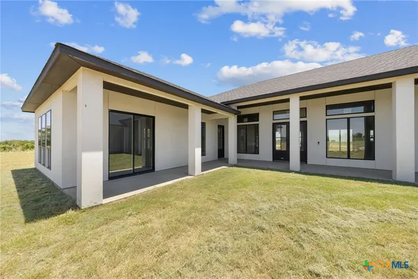a view of a house with a swimming pool and a yard