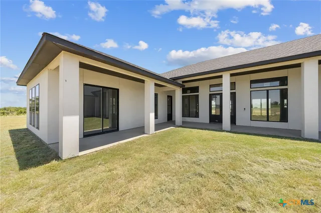 a view of a house with a swimming pool and a yard