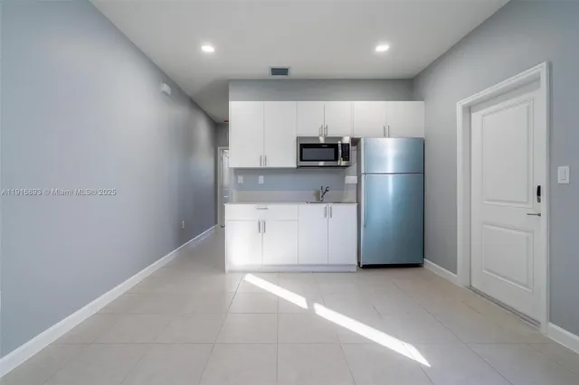 a view of kitchen with stainless steel appliances a refrigerator and a stove