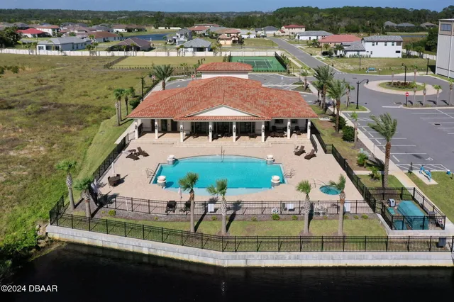 an aerial view of a house with balcony and outdoor space