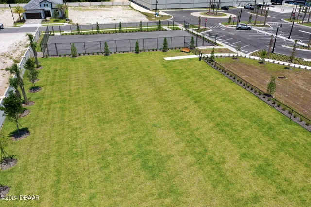 an aerial view of a house with a garden and lake view