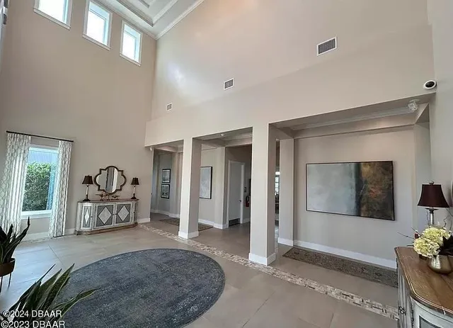 a kitchen with a dining table chairs and white cabinets