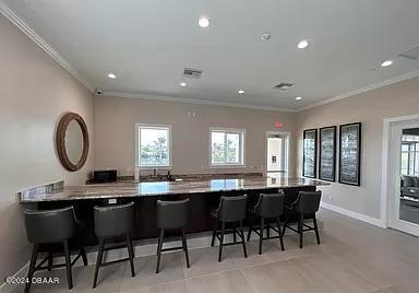 10 Rio Vista Drive Palm Coast, FL 32137 - Photo 33 of 39 a kitchen with a dining table chairs and white cabinets